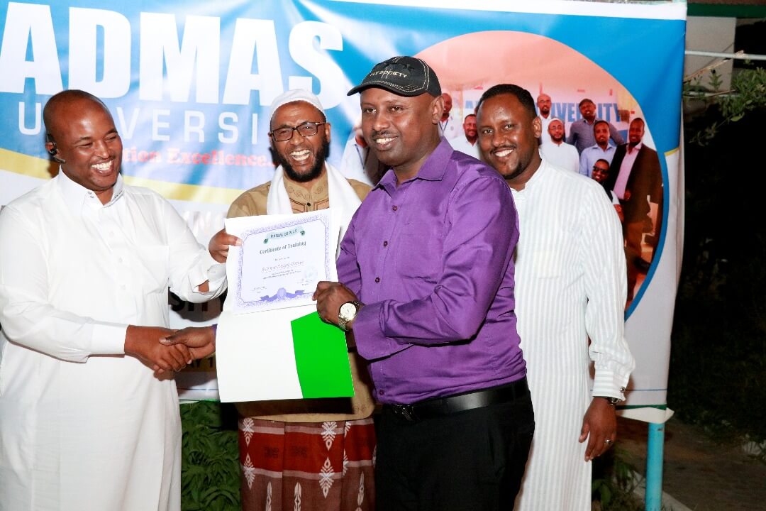 another male admas worker receives his certificate